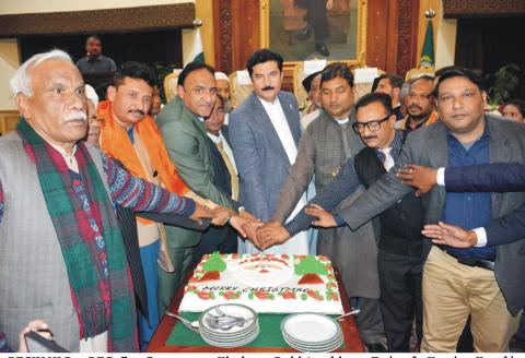 Governor Khyber Pakhtunkhwa Faisal Karim Kundi cutting a Christmas Cake with minorities during a grand Christmas celebration function at Governor House peshawar arranged by PPP Minorities Wing Khyber Pakhtunkhwa.